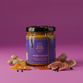 Jar of 'Immunity Booster' with ingredients on a pink background
